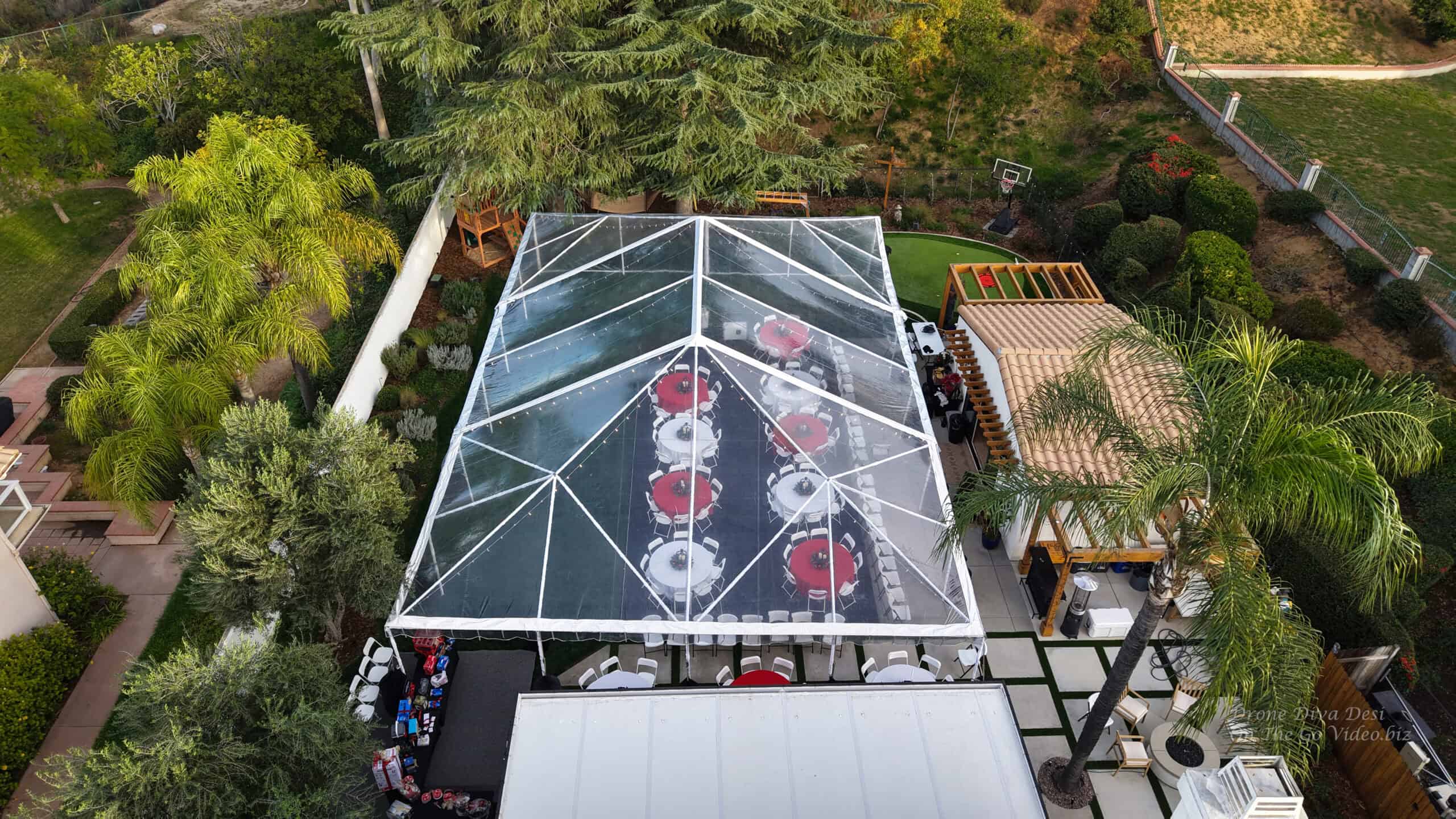 Aerial view of a clear-top Titan event tent set for a celebration