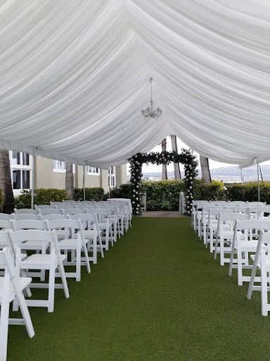 Rows of padded chairs with a special draped tent above.
